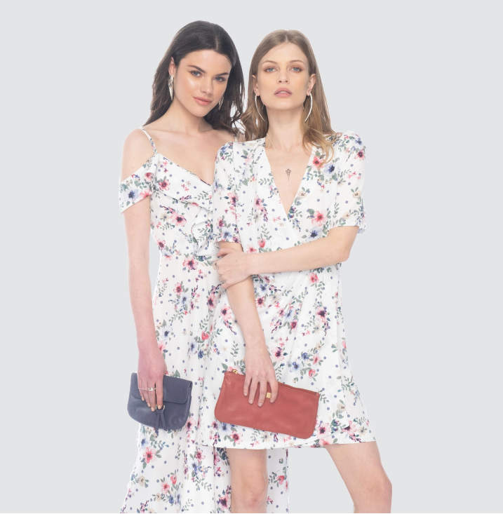 Two women in matching floral summer dresses