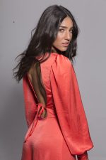 Woman in coral summer dress