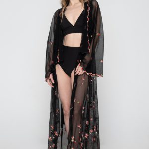 Woman wearing black beachwear kimono