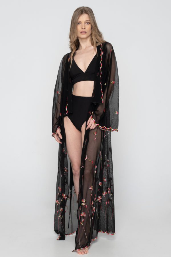 Woman wearing black beachwear kimono