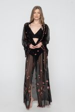 Woman wearing black beachwear kimono