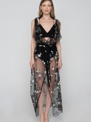 Woman wearing a black floral beachwear kimono