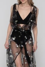 Woman wearing a black floral beachwear kimono
