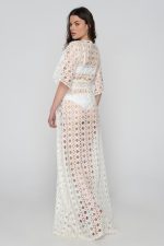 Woman wearing a white beachwear dress