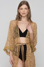 Woman wearing a golden beachwear dress